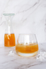 Two glass of homemade Kombucha on the marble table, healthy fermented tea beverages.