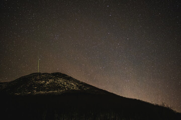 Night sky with green shooting star at Franconia Notch State Park, White Mountains