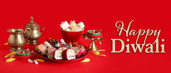 Naklejka premium Diya lamps with candles and plates of different treats on red background. Divaly celebration