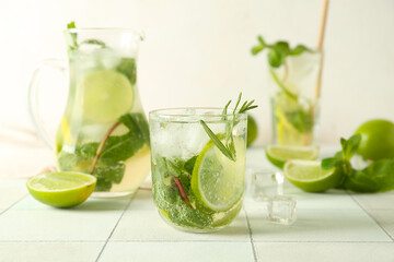 Glass of tasty mojito on table