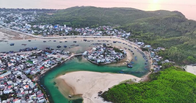 Aerial view of Sa Huynh Bay, including fishing village, transportation system, urban area, the most beautiful beach in Central Vietnam