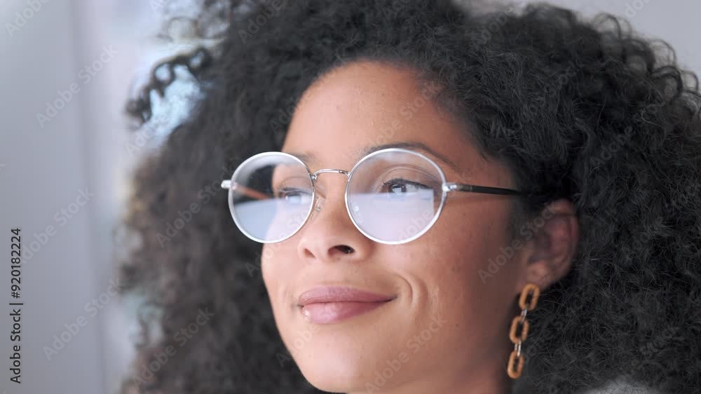 Poster businesswoman with trendy glasses reading information on a computer screen while working in an offic