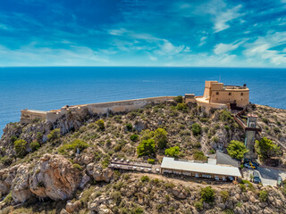 Naklejka premium Aerial view of San Juan fort and popular beach in Aguilas Spain, popular Mediterranean tourist destination with turquoise water
