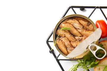 Canned smoked sprats with parsley and tomatoes on white background