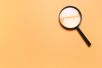 Black magnifier on orange background