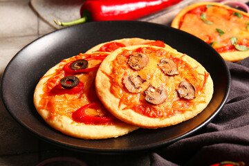 Plate with different tasty mini pizzas, closeup