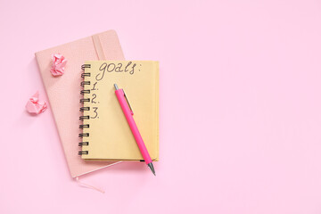 Notebooks with empty to do list and pen on pink background. New year goals