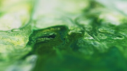 Blur wave. Ink splash. Defocused green white color marble particles texture liquid emulsion stream...