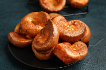 Plate with tasty Yorkshire pudding on blue background