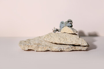 Decorative stone podiums with eucalyptus on beige background