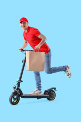 Young courier with bag of food riding electric scooter on blue background