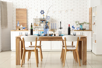Festive table setting with Hanukkah decorations in kitchen