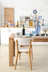 Festive table setting with Hanukkah decorations in kitchen
