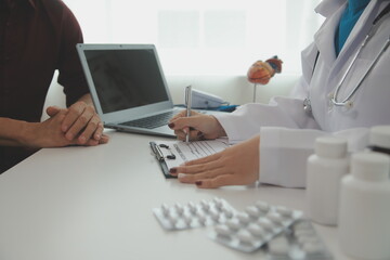 Doctor prescribing medicine giving pills to senior grandmother patient at hospital.