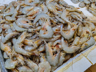 piles of fresh raw shrimp for sale at a traditional market