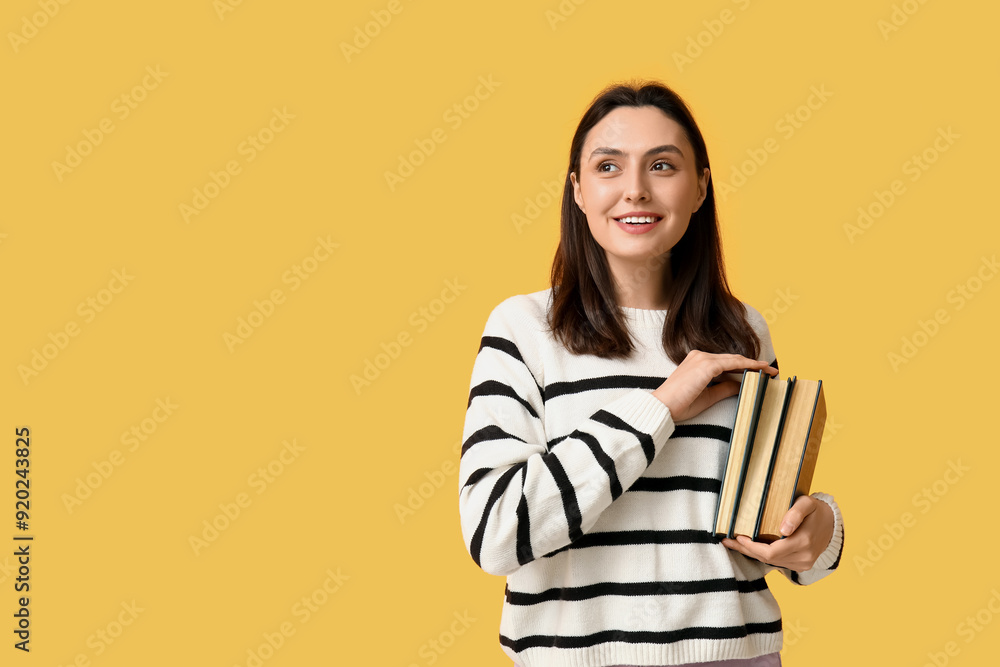 Canvas Prints Young woman with books on orange background