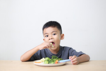 Nutrition healthy eating habits for kids concept. Children do not like to eat vegetables. Little cute boy refuses to eat healthy vegetables.
