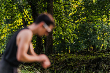 Background of an out-of-focus athlete training in nature. Copy space