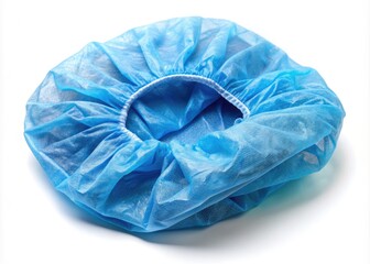 Fototapeta premium Sterile blue surgical bouffant hair cap on a white background, crumpled and empty, awaiting use in a medical or healthcare setting for hygiene and protection.