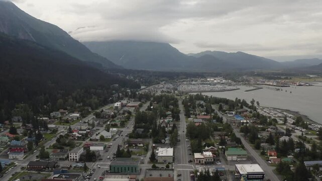 Downtown Seward, Alaska harbor town with boats, buildings, and mountain landscape along Resurrection Bay on the Kenai Peninsula of Alaska - 4K Drone
