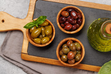 An assortment of various olives presented in a bowl, showcasing different colors, textures, and flavors