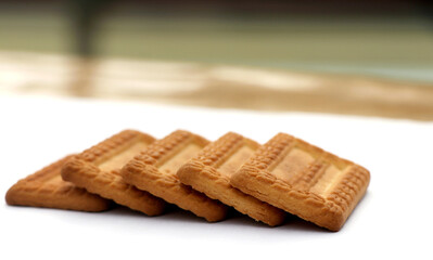 Indian biscuits stacked over white background
