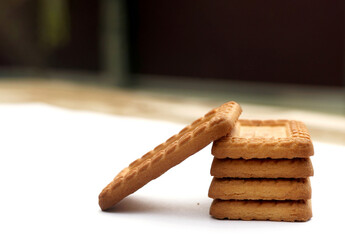 Indian biscuits stacked over white background
