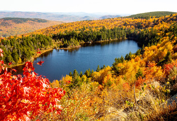 Fall foliage colors surrounding Lake Solitude in Newbury, New Hampshire.