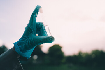 The woman conducted outdoor biology research, using a test tube in the field to perform chemical analysis, demonstrating the practical application of science.