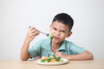 Nutrition healthy eating habits for kids concept. Children do not like to eat vegetables. Little...