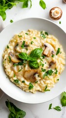 A pleasing plate of mushroom risotto finished with a garnish of fresh basil leaves and herbs, creating a comforting and delicious Italian meal, perfect for dining.