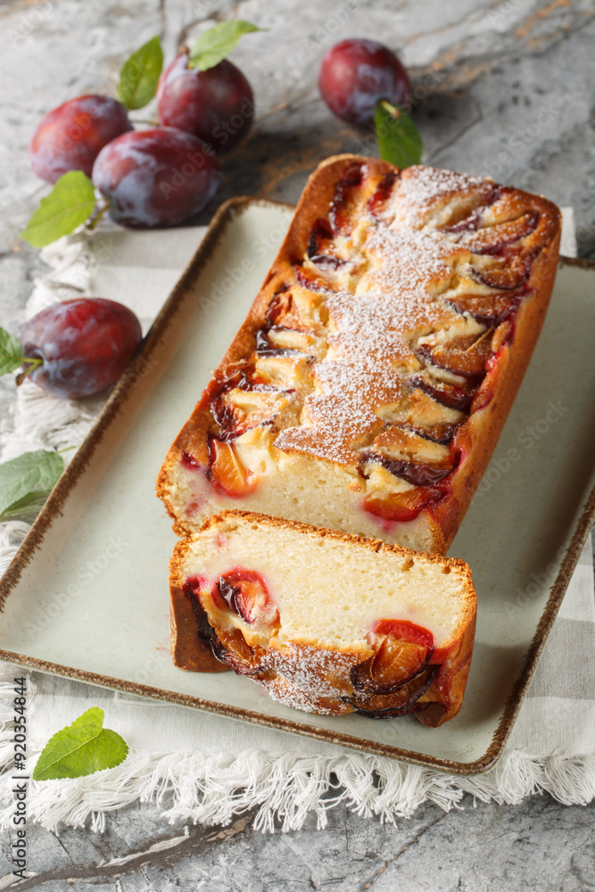 Wall mural Italian Yogurt Plum Cake Torta di Susine closeup on the plate on the table. Vertical