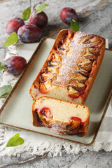 Italian Yogurt Plum Cake Torta di Susine closeup on the plate on the table. Vertical