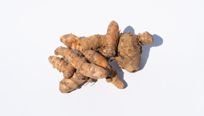 Single Turmeric Root Lying on a White Surface, Emphasizing Its Natural Form and Texture