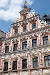 Polychrome facade in Renaissance style of 'Haus zum Breiten Herd' in the historic center of Erfurt, Germany, with a figure representing a mercenary soldier at the top