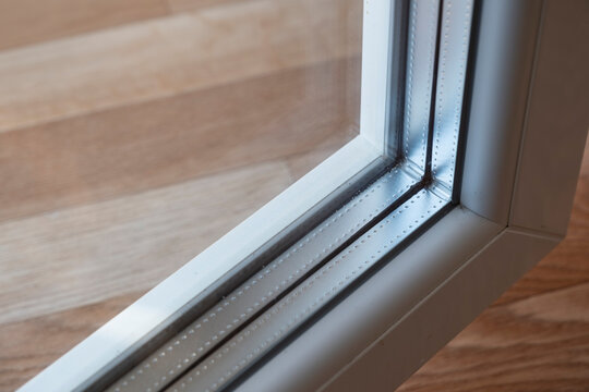 Fototapeta Detail of a window frame with triple glazing. The space between panes is filled with an inert gas, usually argon or krypton