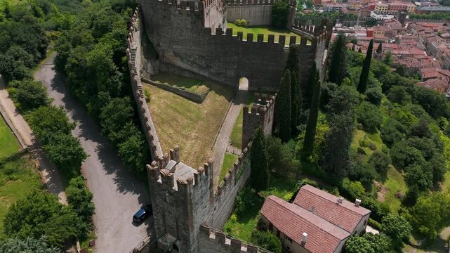 Aerial orbit above Soave Castle towers and walls overlooking town in Italy