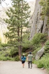 Couple walking next to a cliff outdoors