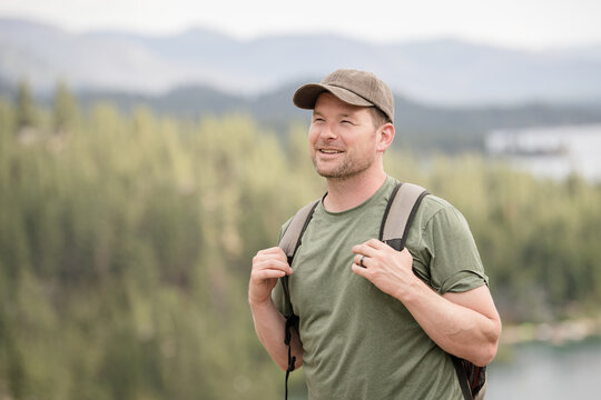 White male hiker smiling with beautiful scenery behind