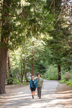 Couple walking towards the camera on a path together
