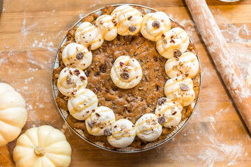 Chocolate chip cookie pie topped with whipped cream and chooclat