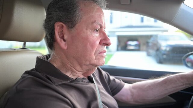senior citizen driver carefully navigates driving through the neighborhood