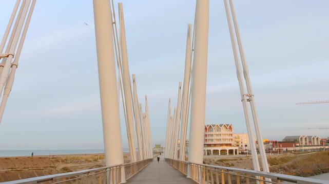 Tilt down shot of "La passerelle du Grand Large" that connects the beach of Malo-les-Bains to the new museum district of Dunkirk next to the marina in Dunkirk, France.