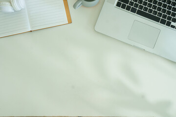 Working desk with laptop computer, mouse, coffee cup and stationery . Top view with copy space.