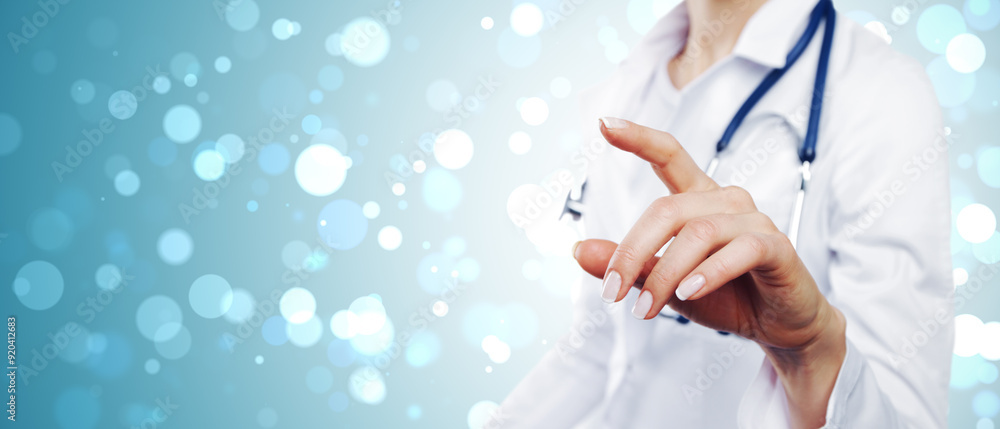 Poster close up of woman doctor hand using abstract digital interface on blurry blue bokeh circles backgrou