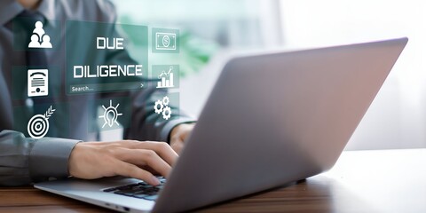 A businessman using laptop with Due diligence visual concept.