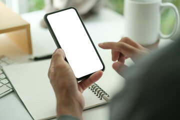 close-up of a person holding a smartphone with a blank white screen, indicating the device is ready for input or displaying a generic placeholder.