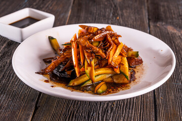 Spicy Pig Ear Salad Dish on wood table. Chinese food. wooden sticks, soy sauce