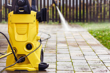 Pressure Washer Karsher. High Pressure Cleaning Paving Block with Pressure Cleaner in Garden Floor....