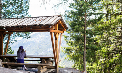 Woman enjoying landscape on a picnic rest area. Healthy lifestyle. Bisse du Rho